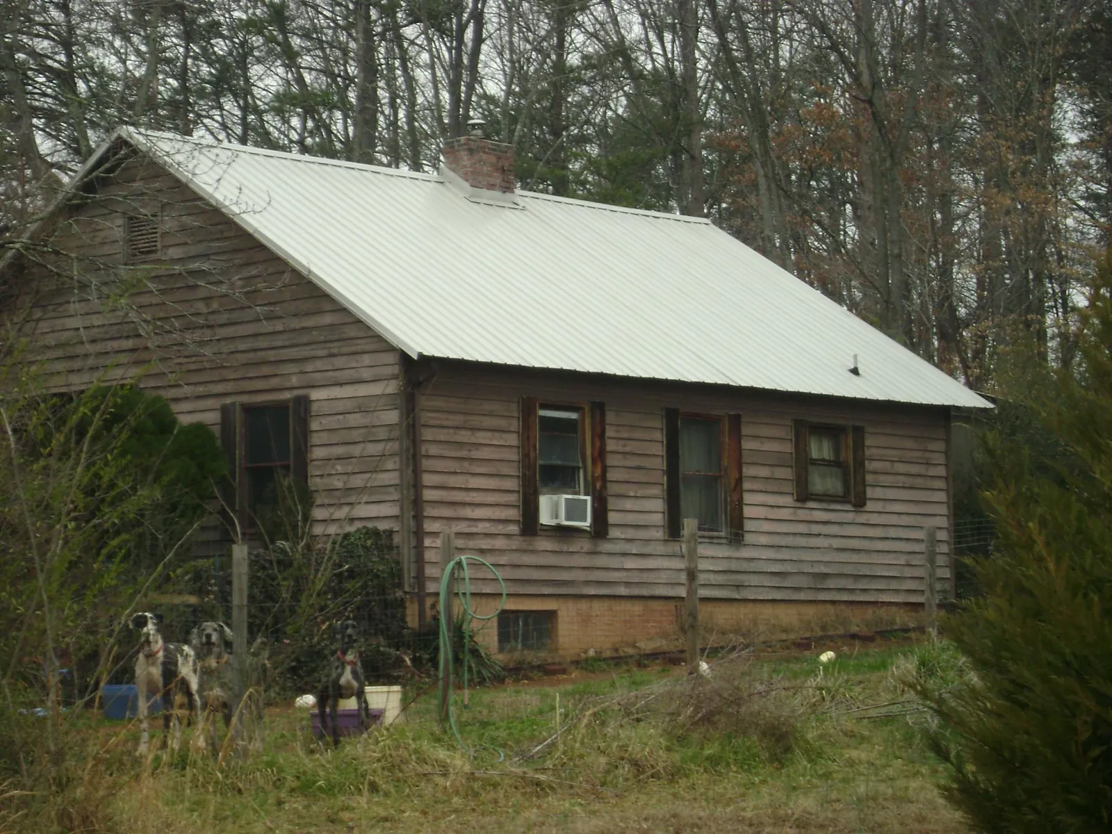 White metal roof on an old wood sided farmhouse, from a Metal Roof Installation job in Mifflinburg